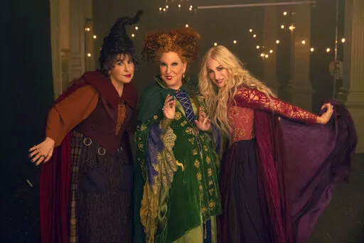 This image released by Disney shows, from left, Kathy Najimy as Mary Sanderson, Bette Midler as Winifred Sanderson, and Sarah Jessica Parker as Sarah Sanderson in "Hocus Pocus 2." (Matt Kennedy/Disney via AP)