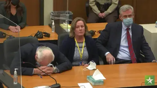 In this screen grab from video, former Brooklyn Center Police Officer Kim Potter center, with defense attorney Earl Gray, left, and Paul Engh sit at the defense table after the verdict is read December, 23, 2021 in Potter's trial for the April 11, 2021, death of Daunte Wright, at the Hennepin County Courthouse in Minneapolis, Minn. Prosecutors appear to have backed away from their pursuit of a longer-than-usual sentence for Potter. In a filing this week ahead of her Friday Feb. 18, 2022, sentenc
