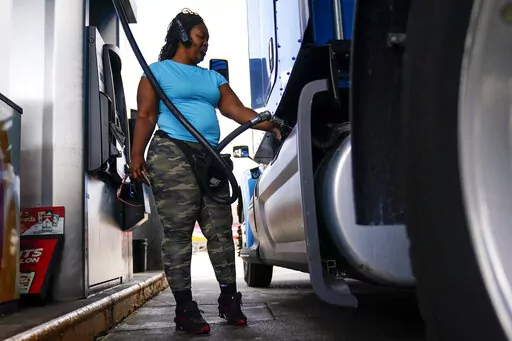 Delores Bledsoe, of Houston, Texas, fuels up her rig at a truck stop in Carlisle, Pa., Wednesday, July 13, 2022. (AP Photo/Matt Rourke)