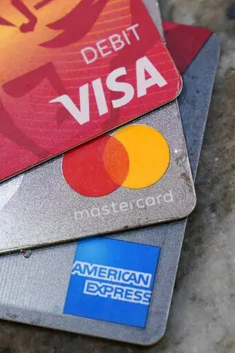 American Express, Visa and Master card cards are on display in Richmond, Va., Thursday, July 1, 2021.  A group of Republican attorneys general are pushing the major payment networks _ Visa, Mastercard and American Express _ to drop their plans to start tracking sales at gun stores, arguing the plans could infringe on consumer privacy and push legal gun sales out of the mainstream financial network. The letter comes more than a week after the payment networks said they would adopt the Internation