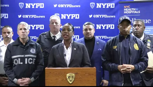 This photo provided by NYPD, New York City Police Commissioner Keechant Sewell address the media during a news conference on Saturday, Dec. 31, 2022. A man wielding a machete attacked three police officers at the New Year’s Eve celebration in New York City, authorities said, striking two of them in the head before an officer shot the man in the shoulder. The two officers were hospitalized, one with a fractured skull and the other with a bad cut, but expected to recover. (NYPD via AP)