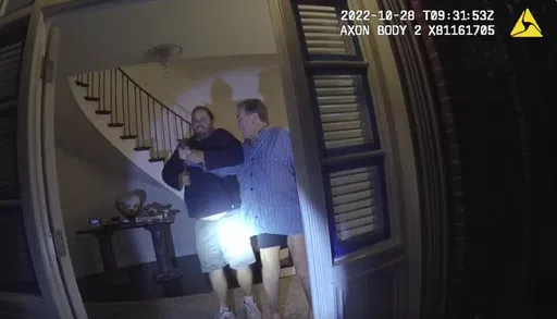 In this image taken from San Francisco Police Department body-camera video, the husband of former U.S. House Speaker Nancy Pelosi, Paul Pelosi, right, fights for control of a hammer with his assailant David DePape during a brutal attack in the couple's San Francisco home, on Oct. 28, 2022. DePape convicted of attempting to kidnap then-House Speaker Nancy Pelosi and attacking her husband with a hammer is set to be sentenced in federal court Friday, May 17, 2024. (San Francisco Police Department v