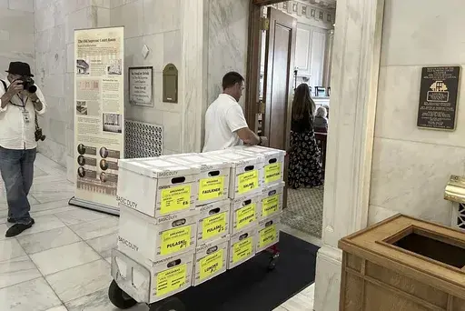 Boxes of petitions for proposal aimed at blocking a planned casino are delivered to the Capitol in Little Rock, Ark., on July 5, 2024. (AP Photo/Andrew DeMillo, File)