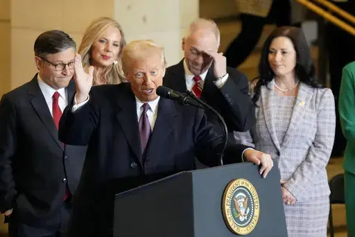 President Donald Trump speaks from Emancipation Hall as House Speaker Mike Johnson, from left, his wife Kelly Johnson, House Majority Leader Steve Scalise, R-La., and his wife Jennifer Scalise, listen after the 60th Presidential Inauguration, Monday, Jan. 20, 2025, at the U.S. Capitol in Washington. (Jasper Colt/Pool Photo via AP)