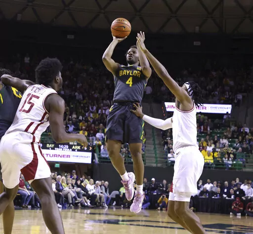 Baylor guard LJ Cryer (4) scores over Arkansas guard Ricky Council IV, right, in the first half of an NCAA college basketball game, Saturday, Jan. 28, 2023, in Waco, Texas. (Rod Aydelotte/Waco Tribune-Herald via AP)