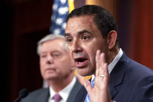 Rep. Henry Cuellar, D-Texas, with Sen. Lindsey Graham, R-S.C., speaks about the United States-Mexico border during a news conference at the Capitol in Washington, July 30, 2021. The 2022 midterm election season opens Tuesday, March 1, in Texas. Cuellar is facing a progressive challenger just weeks after FBI agents raided his home. (AP Photo/Manuel Balce Ceneta, File)