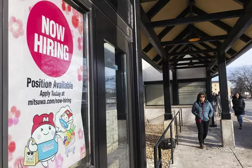 A hiring sign is displayed at a grocery store in Arlington Heights, Ill., Tuesday, Dec. 27, 2022. On Thursday, the Labor Department reports on the number of people who applied for unemployment benefits last week. (AP Photo/Nam Y. Huh, File)