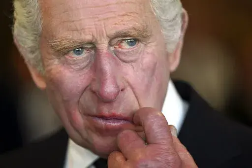 Britain's King Charles III gestures during a visit to the Metropolitan Police Service Special Operations Room (SOR) to thank Emergency Service workers for their work and support, ahead of the funeral of late Queen Elizabeth II, at the Lambeth headquarters in London, Saturday, Sept. 17, 2022.  King Charles III faces the task of preserving a 1,000-year-old monarchy that his mother nurtured for seven decades but that faces an uncertain future. The challenge is immense. (Carl de Souza/Pool via AP, F