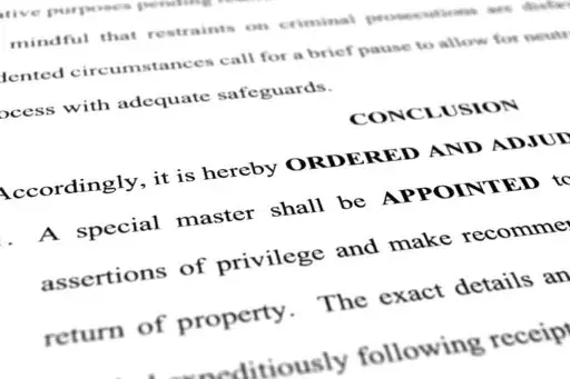A page from the order granting a request by former President Donald Trump's legal team to appoint a special master to review documents seized by the FBI during a search of his Mar-a-Lago estate is photographed Monday, Sept. 5, 2022. The decision by U.S. District Judge Aileen Cannon came despite the objections of the Justice Department, which said an outside legal expert was not necessary in part because officials had already completed their review of potentially privileged documents. (AP Photo/J