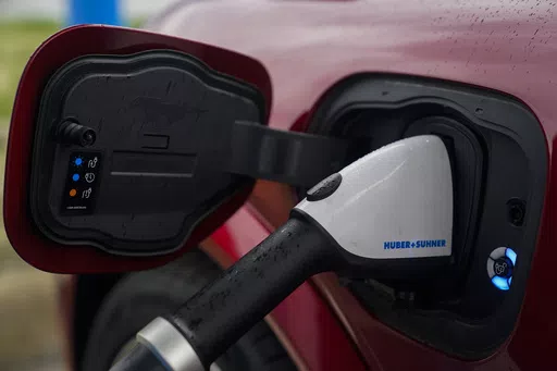 A 2023 Ford Mustang Mach-E charges, Friday, March 8, 2024, at an electric vehicle charging station in London, Ohio. The U.S. government has loosened some rules governing electric vehicle tax credits a bit, potentially making more EVs eligible for credits of up to $7,500. The Treasury Department announced final regulations for the credits under the 2022 Inflation Reduction Act on Friday, May 3, giving automakers more time to comply with some provisions about where battery minerals can come from. 