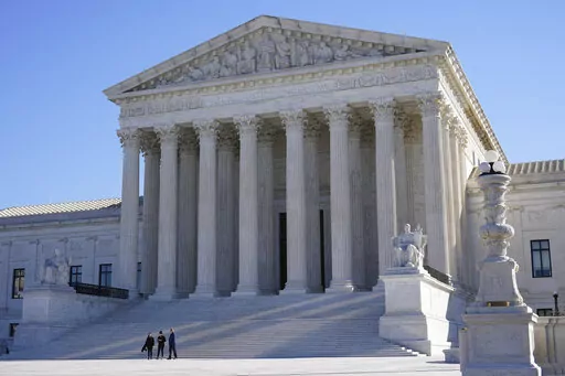 Visitors walk outside the Supreme Court building on Capitol Hill in Washington, Feb. 21, 2022.  (AP Photo/Patrick Semansky, File)