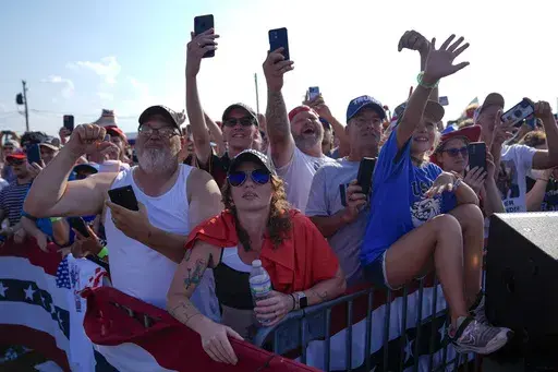 Supporters cheer as Republican presidential candidate former President Donald Trump arrives for a campaign rally, Saturday, July 13, 2024, in Butler, Pa. Two very different conspiracy theories are spreading in the days following Trump's attempted assassination. For some Trump supporters, the failure of the Secret Service to stop the shooter before he fired at Trump suggests a conspiracy orchestrated by President Joe Biden. For some Trump critics, however, the same video footage is being used to 