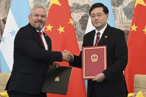 Honduras Foreign Minister Eduardo Enrique Reina Garcia, left, and Chinese Foreign Minister Qin Gang shake hands following the establishment of diplomatic relations between the two countries, at a ceremony in the Diaoyutai State Guesthouse in Beijing Sunday, March 26, 2023. Honduras formed diplomatic ties with China on Sunday after breaking off relations with Taiwan, which is increasingly isolated and now recognized by only 13 sovereign states, including Vatican City. (Greg Baker/Pool Photo via A
