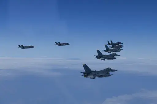 In this photo provided by South Korea Defense Ministry, U.S. and South Korea Air Force fighter jets fly in formation during a joint drill on Tuesday, June, 7, 2022. The South Korean and U.S. militaries flew 20 fighter jets over South Korea's western sea Tuesday in a continued show of force as a senior U.S. official warned of a forceful response if North Korea goes ahead with its first nuclear test explosion in nearly five years. (South Korea Defense Ministry via AP)