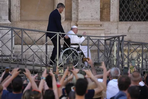 FILE-- Pope Francis greets the faithful as he leaves St. Mary Major Basilica after participating in a rosary prayer for peace, in Rome, Tuesday, May 31, 2022. Pope Francis canceled a planned July trip to Africa on doctors' orders because of ongoing knee problems, the Vatican said Friday, June 10, 2022, raising further questions about the health and mobility problems of the 85-year-old pontiff.  (AP Photo/Gregorio Borgia)