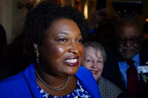 Georgia gubernatorial Democratic candidate Stacey Abrams talks to the media after qualifying for the 2022 election on Tuesday, March 8, 2022, in Atlanta.  Abrams has become a millionaire. A disclosure filed in March shows the candidate for governor is worth $3.17 million, thanks mostly to book and speaking income. Abrams was worth $109,000 in 2018 when she first ran for governor. (AP Photo/Brynn Anderson, File)