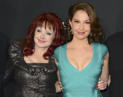 Naomi Judd, left, and Ashley Judd arrive at the LA premiere of "Olympus Has Fallen" in Los Angeles on March 18, 2013. Ashley Judd encouraged people to seek help for their mental health after the loss of her mother, country star Naomi Judd, in an interview on “Good Morning America." Naomi Judd died at the age of 76 on April 30, 2022. (Photo by Jordan Strauss/Invision/AP, File)