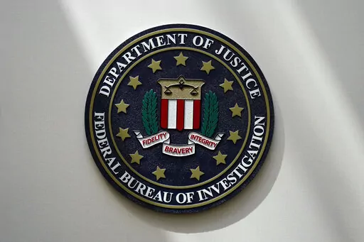 The FBI seal is pictured in Omaha, Neb., Aug. 10, 2022. The FBI is searching for a Florida woman who was supposed to stand trial Monday, March 6, 2023, on charges stemming from the Jan. 6, 2021, Capitol attack as well as another riot defendant who has gone missing. An FBI agent said Monday that a federal judge in Washington issued bench warrants for the arrest of Olivia Pollock and Joseph Hutchinson III last week after the court was notified that they had tampered with or removed the ankle monit
