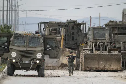 Israeli army vehicles are seen during a military operation in the West Bank city of Jenin, Wednesday, Jan. 22, 2025. (AP Photo/Majdi Mohammed)