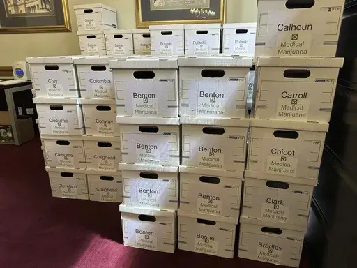 Boxes of petitions signed for a proposed ballot measure expanding Arkansas' medical marijuana program sit in a committee room at the Arkansas state Capitol in Little Rock, Ark. on Friday, July 5, 2024. The measure is among several that faced a Friday deadline to submit signatures to qualify for the November ballot. (AP Photo/Andrew DeMillo)