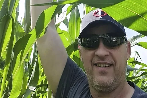 In this image courtesy of Kristi Magnusson, Kurt Groszhans in one of his fields in Ukraine in July 2021. The American farmer is jailed in Ukraine on charges he attempted to assassinate a former business partner who is now a government minister. The family of Groszhans says the charges are bogus and designed to stifle his claims of corruption. His former partner, Roman Leshchenko, has denied that he embezzled money from the American's company. (Kristi Magnusson via AP)