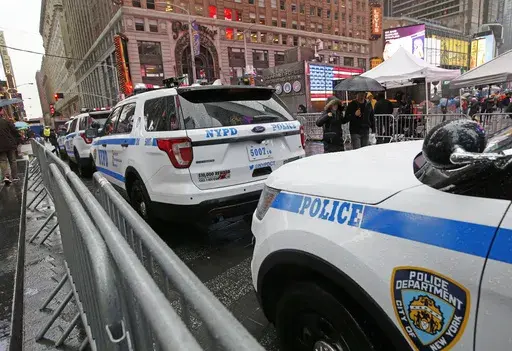 A line of police cars are parked along a street in Times Square, Thursday, Dec. 29, 2016, in New York. A New York City police officer is speaking out against the use of "courtesy cards" by friends and relatives of his colleagues on the force, accusing department leaders of maintaining a sprawling system of impunity that lets people with a connection to law enforcement avoid traffic tickets. (AP Photo/Kathy Willens, File)
