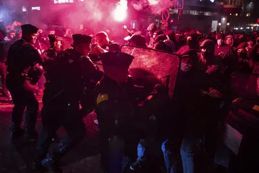 Protesters and police clash during a rally against the "Israel is Forever" gala organized by far-right Franco-Israeli figures, in Paris, Wednesday, Nov. 13, 2024, on the eve of the UEFA Nations League 2025 soccer match between France and Israel. (AP Photo/Louise Delmotte)