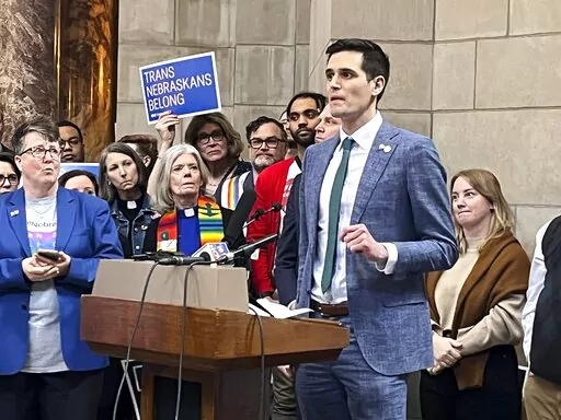 Omaha Sen. John Fredrickson, the first openly gay man elected to the Nebraska Legislature, speaks before a crowd on Wednesday, Feb. 8, 2023, at the state Capitol in Lincoln, Neb. The crowd assembled to protest a bill that would ban gender-affirming medical procedures, including hormone therapy and surgical reassignment, for those 19 and younger. (AP Photo/Margery A. Beck)