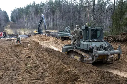 Recovery efforts continue for four missing U.S. soldiers near the spot where their Hercules armored vehicle was found submerged at a training range in Pabrade, north of the capital Vilnius, Lithuania on Thursday, March 27, 2025. (AP Photo/Mindaugas Kulbis)