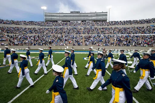 Air Force Academy cadets make their way to their seats as family and friends cheer from the stands during the United States Air Force Academy's Class of 2021 graduation ceremony at the USAFA in Colorado Springs, Colo., May 26, 2021. Three cadets at the U.S. Air Force Academy who have refused the COVID-19 vaccine will not be commissioned as military officers but will graduate with bachelor's degrees, the academy said Saturday, May 21, 2022. (Chancey Bush/The Gazette via AP, File)
