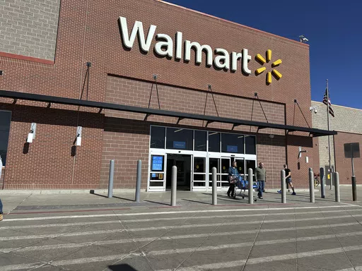 Shoppers exit a Walmart store, Feb. 21, 2024, in Englewood, Colo. Walmart on Tuesday, May 14, 2024, announced layoffs affecting several hundred jobs at the retail giant’s campus offices. (AP Photo/David Zalubowski, File)