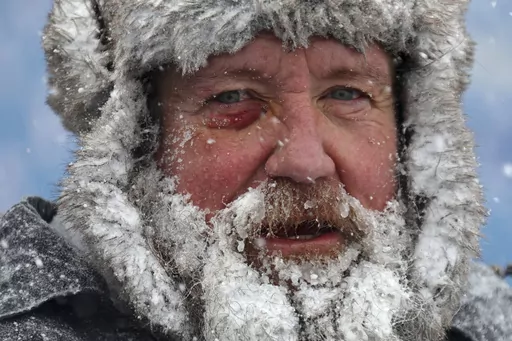 A worker pauses while removing snow from Highmark Stadium in Orchard Park, N.Y., Jan. 14, 2024. While the U.S. is shivering through bone-chilling cold, most of the rest of world is feeling unusually warm weather. Scientists Tuesday, Jan. 16, say that fits with what climate change is doing to Earth. (AP Photo/ Jeffrey T. Barnes, File)