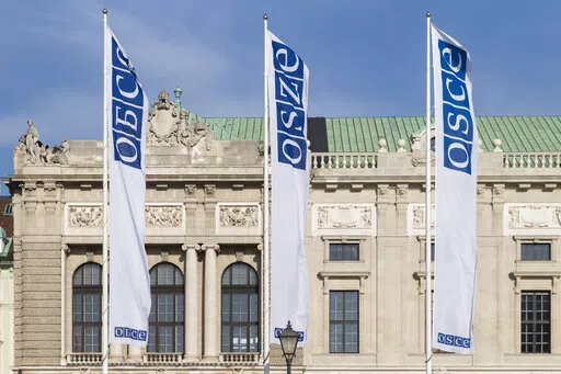 Flags wave in the wind in front of the entrance of the Permanent Council of the Organization for Security and Cooperation in Europe, OSCE, in Vienna, Austria, Feb. 15, 2022. Neutral Austria has come under heavy criticism for granting visas to sanctioned Russian lawmakers for a meeting of the Organization for Security and Cooperation in Europe in Vienna from Feb. 23 until Feb. 24, 2023. The issue highlights the delicate balancing act the European country has engaged in while trying to maintain it