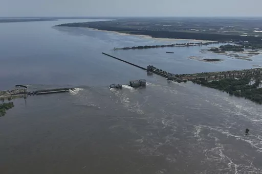 CAPTION CORRECTS LOCATION - Water flows over the collapsed Kakhovka Dam in Nova Kakhovka, in Russian-occupied Ukraine, Wednesday, June 7, 2023. (AP Photo)