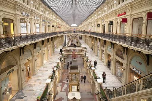 Small number of visitors walk inside the GUM department store in Moscow, in Moscow, Russia, Friday, March 4, 2022. (AP Photo, File)