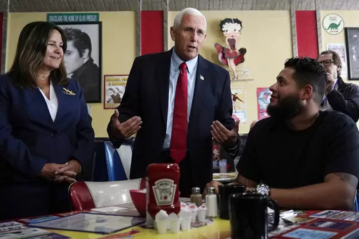 Republican presidential candidate former Vice President Mike Pence and his wife Karen, left, chat with a patrons during a campaign stop at a diner, June 9, 2023, in Derry, N.H. Weary Republicans who acknowledge Donald Trump's dominance, across New Hampshire are fighting to stop the former president from winning the first-in-the-nation primary. For now, however, they're relying on little more than hope and prayers. Look no further than Pence, who repeatedly appealed to voters' faith as he tried t