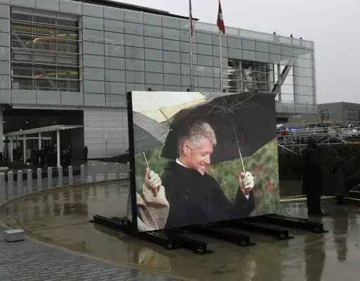 Former President Bill Clinton, by way of video monitor at the William J. Clinton Presidential Center during opening ceremonies in Little Rock, Ark., Nov. 18, 2004. (AP Photo/Lawrence Jackson, File)