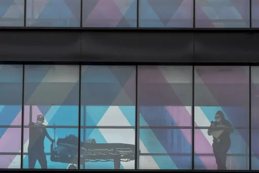 Health care workers are seen from an overpass at Mount Sinai Hospital, Tuesday, March 16, 2021, in New York. The COVID-19 public health emergency that started in January 2020 ended on May 11, 2023. When that happened, several Medicare rules and waivers that went into effect during the pandemic came to an end — and it may catch Medicare patients by surprise. (AP Photo/Mary Altaffer, File)