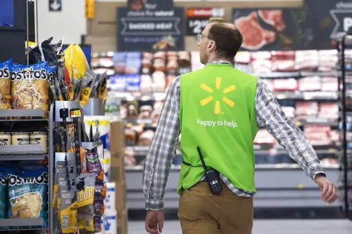 A Walmart associate works at a Walmart Neighborhood Market, Wednesday, April 24, 2019, in Levittown, N.Y.  The nation’s two major retailers _ Walmart and Target_ plan to push deals and other marketing gimmicks for the holiday shopping season earlier than last year as soaring inflation spurs customers to get a jump start on gift giving.   (AP Photo/Mark Lennihan, File)