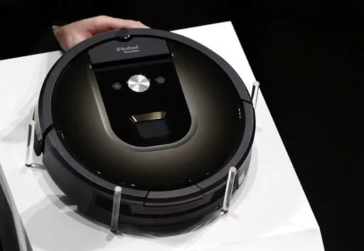 A Roomba 980 vacuum cleaning robot is presented during a presentation  in Tokyo, Tuesday, Sept. 29, 2015. Amazon on Friday, Aug. 5, 2022, announced it has entered into an agreement to acquire the vacuum cleaner maker iRobot for approximately $1.66 billion. The company sells its robots worldwide and is most famous for the circular-shaped Roomba vacuum.  (AP Photo/Eugene Hoshiko)