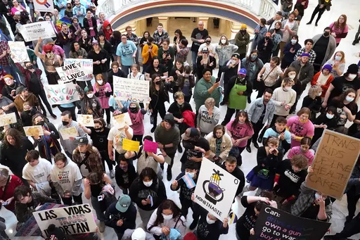 Trans-rights activists protest outside the House chamber at the state Capitol before the State of the State address in Oklahoma City, Feb. 6, 2023. In a ruling late Thursday, Oct. 5, a federal judge in Oklahoma declined to stop a new law from taking effect that makes it a felony crime for health care workers to provide gender-affirming care to young transgender people. (AP Photo/Sue Ogrocki, File)