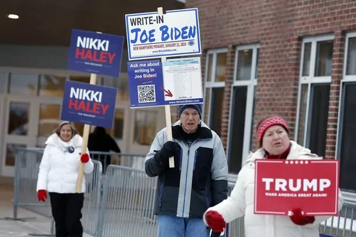 Candidate supporters stand outside a polling location in the presidential primary election, Jan. 23, 2024, in Windham, N.H. Super Tuesday is feeling anything but for many Americans, with the leading presidential contenders already appearing set. A primary season that engages only a fraction of the electorate to choose the presidential candidates is a reminder of how the U.S. election system excludes many voters and differs starkly from that of most other democracies around the world. (AP Photo/M