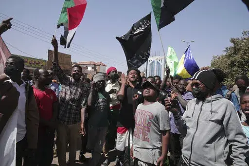 People chant slogans during a anti-coup protests that have rocked the country since a military coup three months ago.in Khartoum, Sudan, Sunday, Jan. 30, 2022. (AP Photo/Marwan Ali)