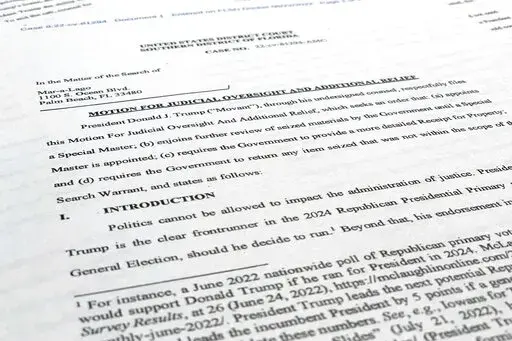 A court filing by lawyers for former President Donald Trump is photographed Monday, Aug. 22, 2022, as lawyers ask a federal judge to prevent the FBI from continuing to review documents recovered from his Florida estate until a neutral special master can be appointed. The attorneys asserted in a court filing, their first since the FBI search of Mar-a-Lago two weeks ago, that the sets of documents taken from the residence were "presumptively" covered by executive privilege. (AP Photo/Jon Elswick)
