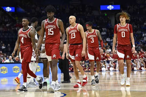 Arkansas players walk to the foul line after a timeout during final minutes of an NCAA college basketball game against Texas A&M in the quarterfinals of the Southeastern Conference Tournament, Friday, March 10, 2023, in Nashville, Tenn. (AP Photo/John Amis)