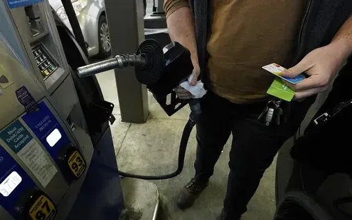 A customer prepares to pump gasoline into his car at a Sam's Club fuel island in Gulfport, Miss., Feb. 19, 2022. The Russia-Ukraine crisis is helping to raise oil and gasoline prices to high levels. Gasoline prices are setting a new record, and they're likely to go higher in the coming weeks. The national average topped $4.17 a gallon on Tuesday, March 8 according to auto club AAA. Californians already pay over $5 on average, and residents in a few other states could soon join them.  (AP Photo/R