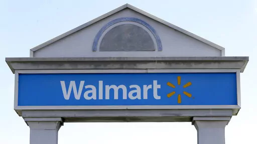 In this Sept. 3, 2019, file photo, a Walmart logo forms part of a sign outside a Walmart store, in Walpole, Mass. Walmart Inc. will  no longer be selling cigarettes in some U.S. stores, a complicated move since tobacco is a money driver for many retailers. The nation's largest retailer, based in Bentonville, Arkansas,  said the removal is  on a store-by-store decision based on the business and particular market. (AP Photo/Steven Senne, File)
