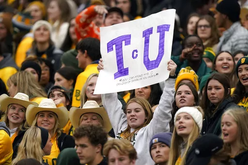 Amongst Baylor fans a lone TCU fan holds up a sign during the first half of an NCAA college football game in Waco, Texas, Saturday, Nov. 19, 2022. (AP Photo/LM Otero)