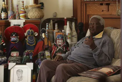 South African photographer Peter Magubane, speaks with The Associated Press during an interview at his home, in Johannesburg, Thursday June 2, 2016. Magubane, a fearless photographer who captured the violence and horror of South Africa’s brutal apartheid era of racial oppression and was then entrusted with documenting Nelson Mandela’s first years of freedom after his release from prison, has died. He was 91. The South African National Editors’ Forum said it had been informed by Magubane's 