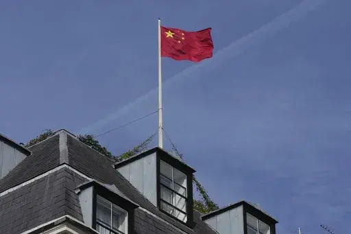 A Chinese national flag is raised at the Chinese embassy in London, Monday, Sept. 11, 2023. (AP Photo/Kin Cheung, File)